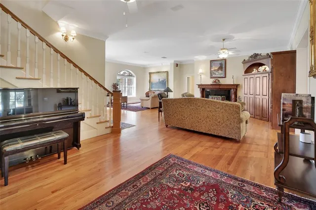 a view of a dining room with furniture a chandelier and wooden floor
