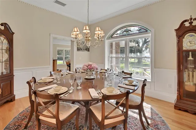 a view of a dining room with furniture wooden floor and chandelier