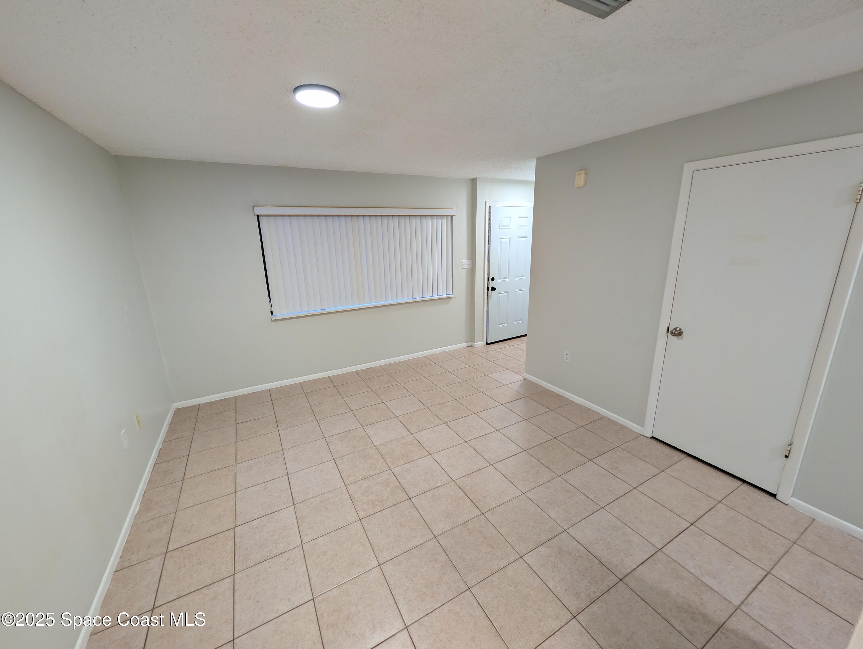 4801 Sisson Road Titusville, FL 32780 - Photo 4 of 21 a view of an empty room and window