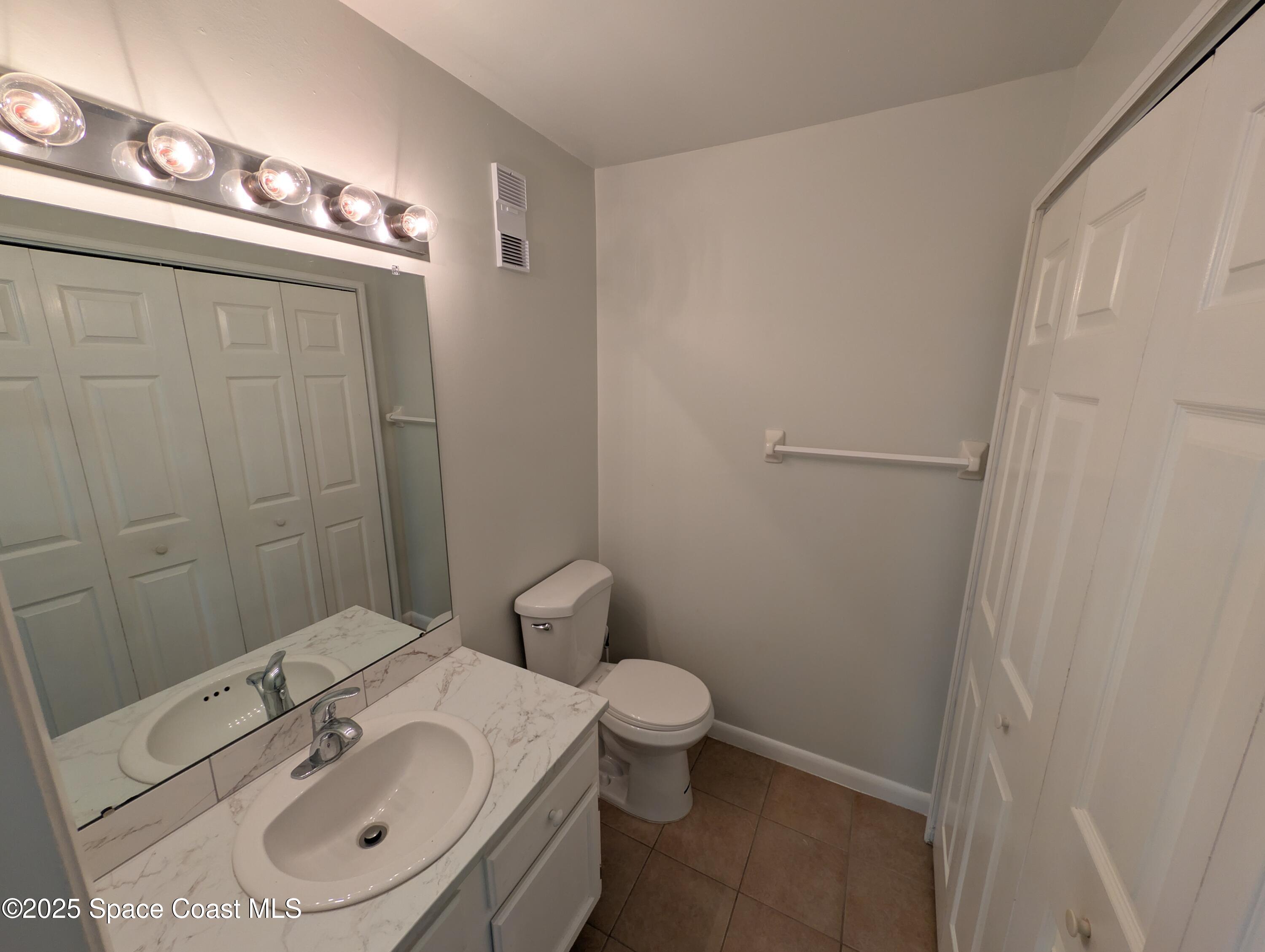 4801 Sisson Road Titusville, FL 32780 - Photo 5 of 21 a bathroom with a sink a toilet and shower
