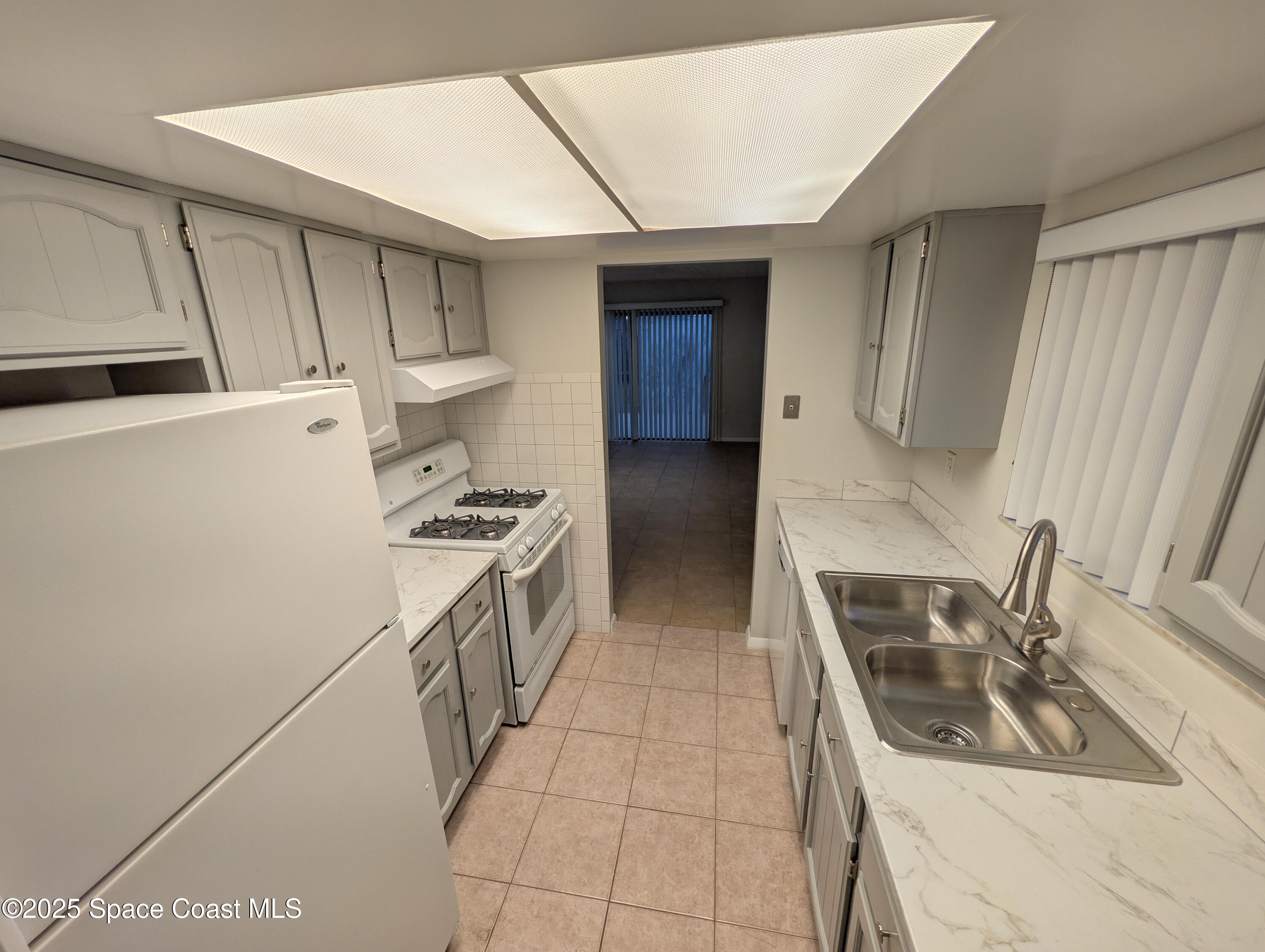 4801 Sisson Road Titusville, FL 32780 - Photo 7 of 21 a kitchen that has a sink and a stove