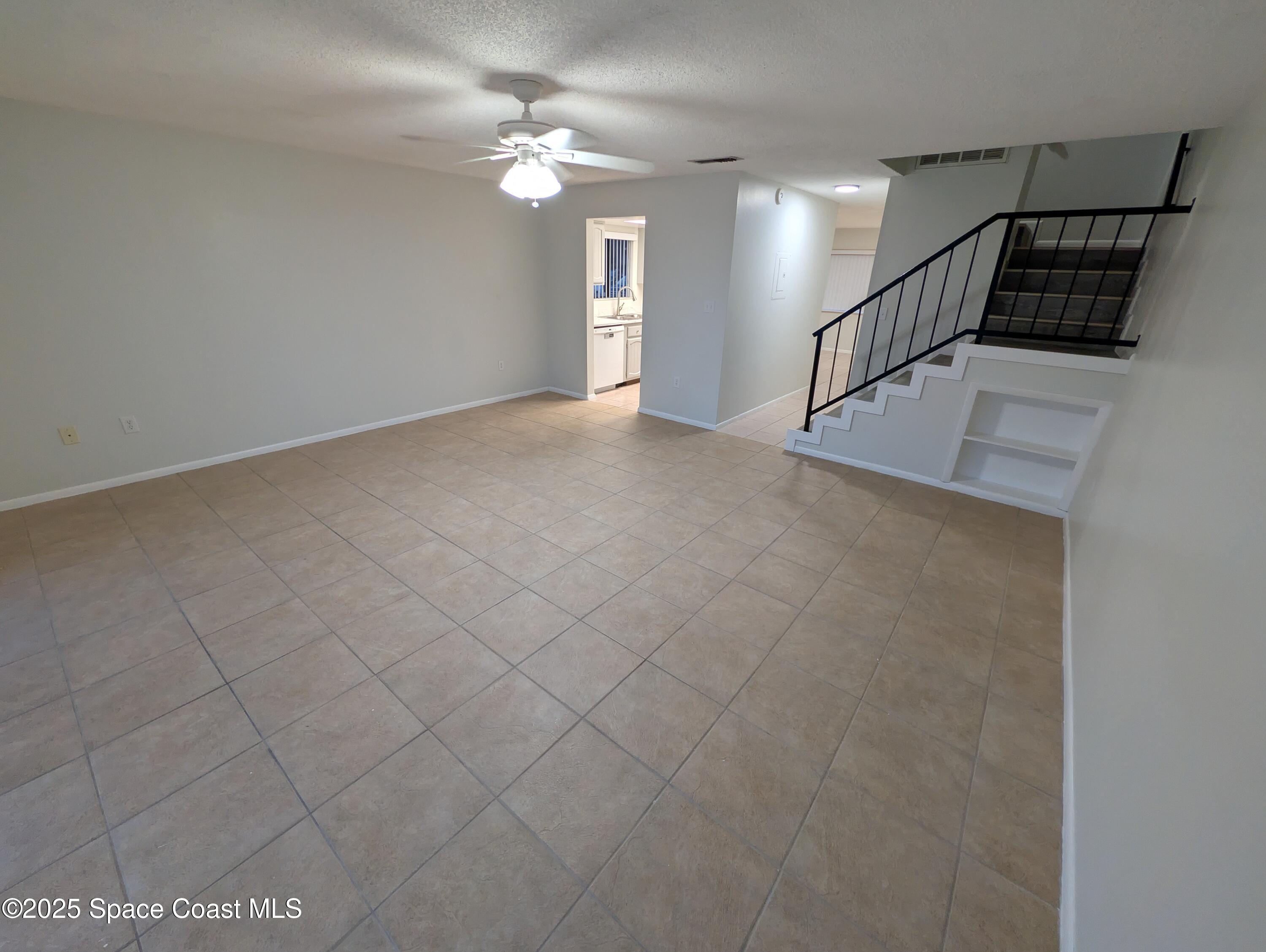 4801 Sisson Road Titusville, FL 32780 - Photo 10 of 21 an empty room with windows and fan