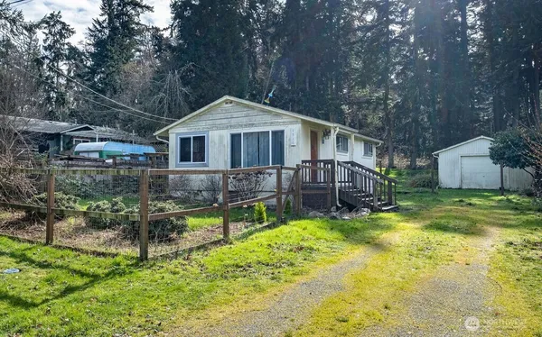 a front view of a house with a yard table and chairs
