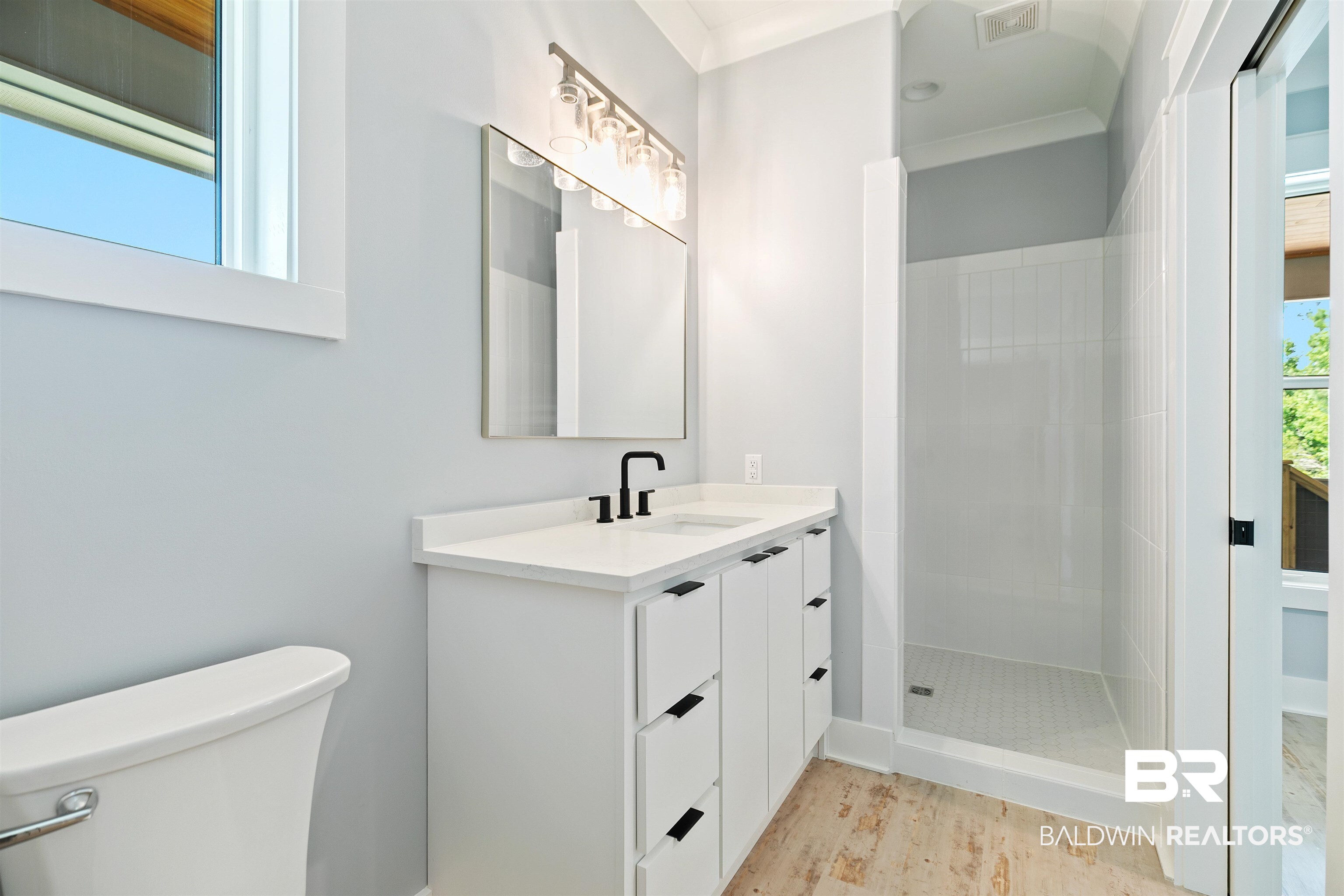 10507 County Road 1 Fairhope, AL 36532 - Photo 20 of 59 Bathroom with tiled shower, vanity, ornamental molding, and toilet