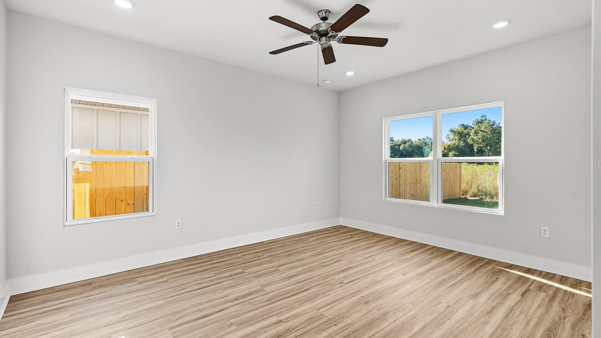 4667 Marine Loop Crestview, FL 32539 - Photo 14 of 34 a view of an empty room with wooden floor and a window