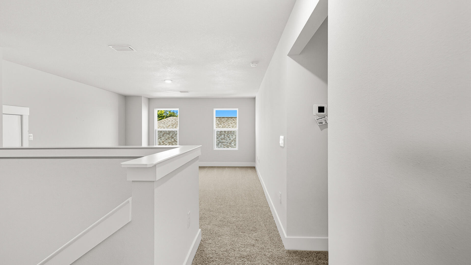 4667 Marine Loop Crestview, FL 32539 - Photo 22 of 34 a view of hallway with window and wooden floor