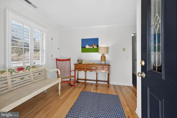 a living room with furniture a rug and a window