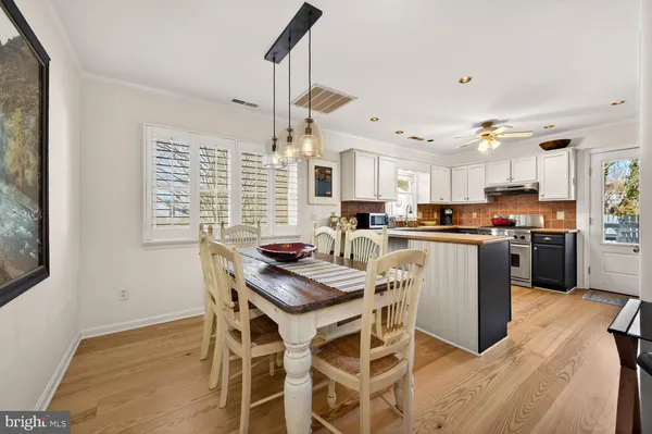 a kitchen with kitchen island a counter top space a sink stainless steel appliances and cabinets