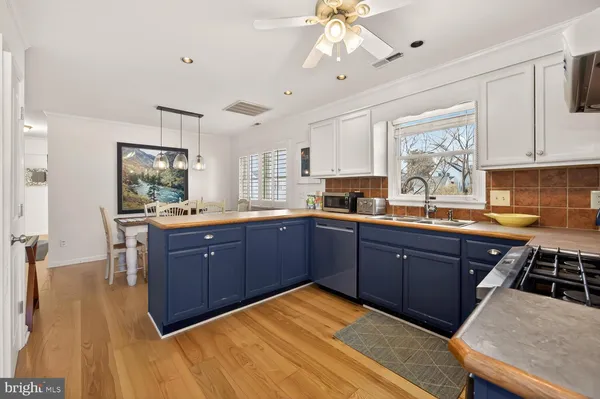 a kitchen with stainless steel appliances granite countertop a sink dishwasher stove and oven with cabinets