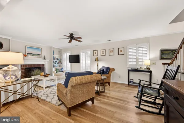 a living room with furniture fireplace and a window