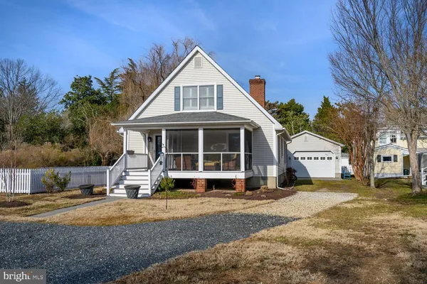 a view of a house with a yard and large trees