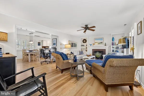 a living room with furniture fireplace and a window
