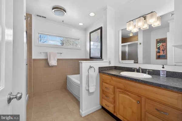 a bathroom with a granite countertop sink mirror and double