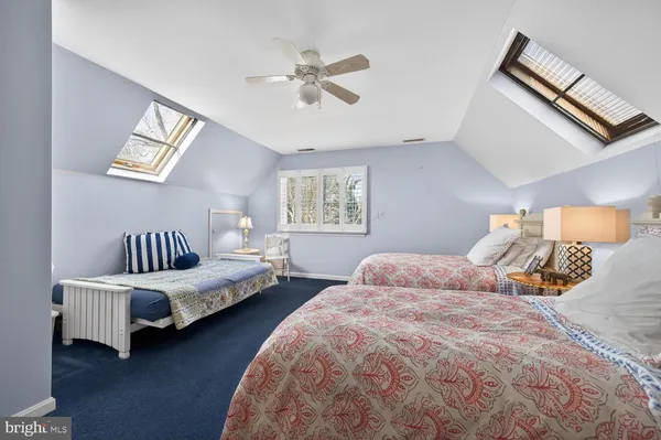 a bedroom with two beds and a chandelier