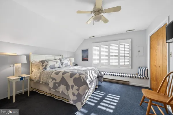 a bedroom with bed and a window
