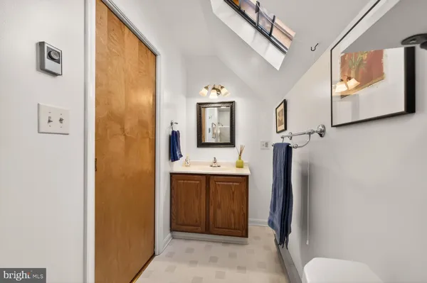 a bathroom with a sink and mirror with toilet