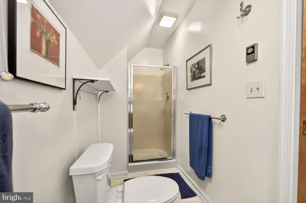 a white toilet sitting next to a bathroom sink and tub