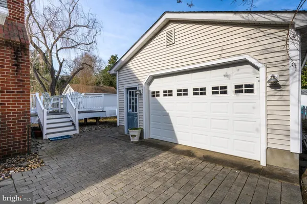 a view of a house with a yard and wooden deck