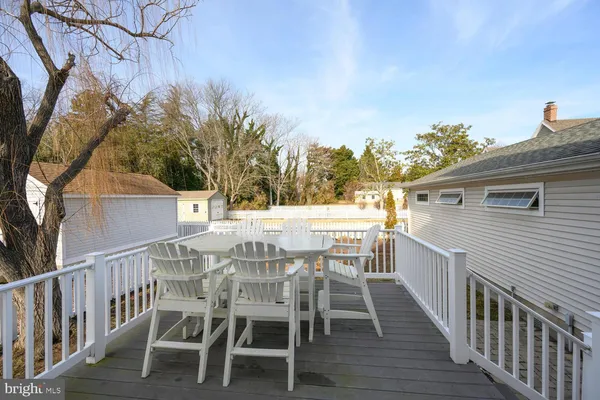 a view of a chairs and table on the deck