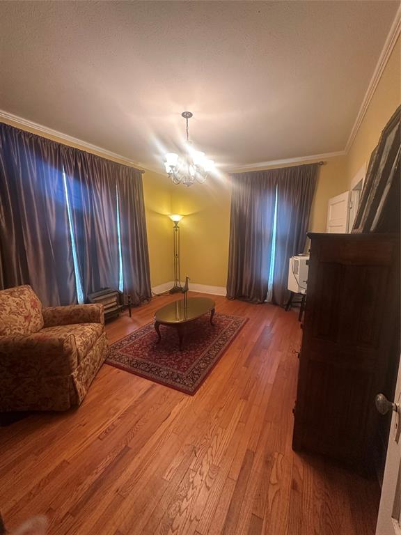 504 1st Street Terrell, TX 75160 - Photo 7 of 27 The room features wood-finish flooring and crown molding
