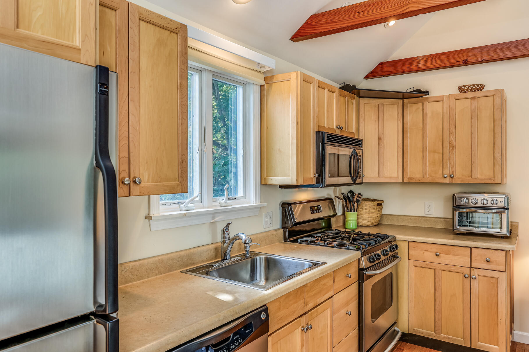 25 Locust Road Eastham, MA 02642 - Photo 17 of 41 a kitchen with a sink and a refrigerator