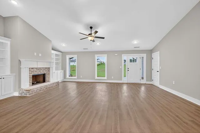 wooden floor in an empty room with a fireplace