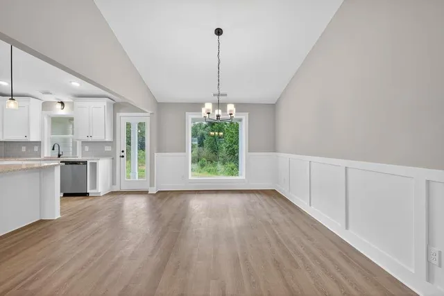 a view of a kitchen with an entryway and wooden floor