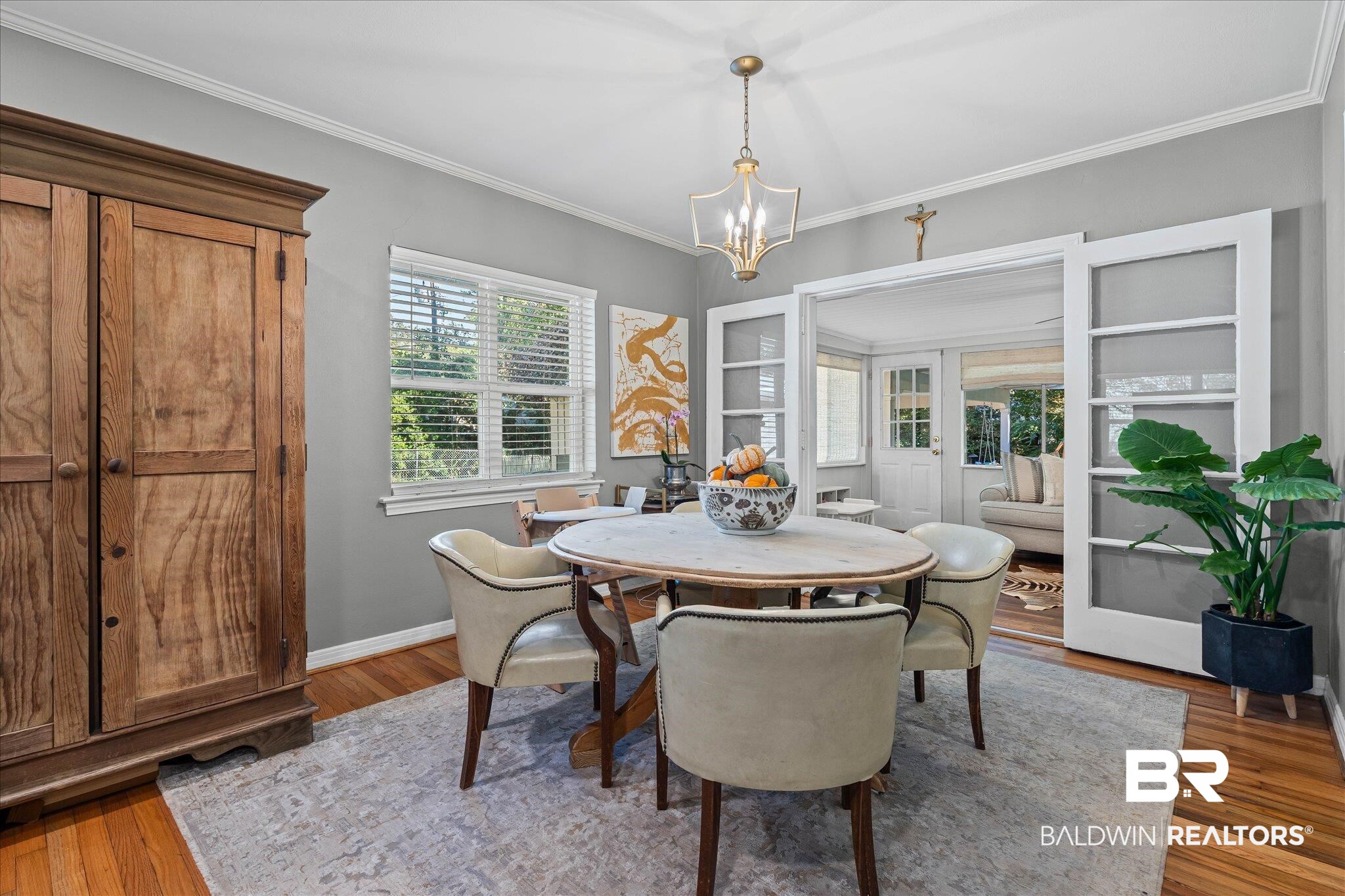 2103 Upham Court Mobile, AL 36607 - Photo 8 of 22 Dining space featuring french doors, ornamental molding, wood finished floors, and a chandelier