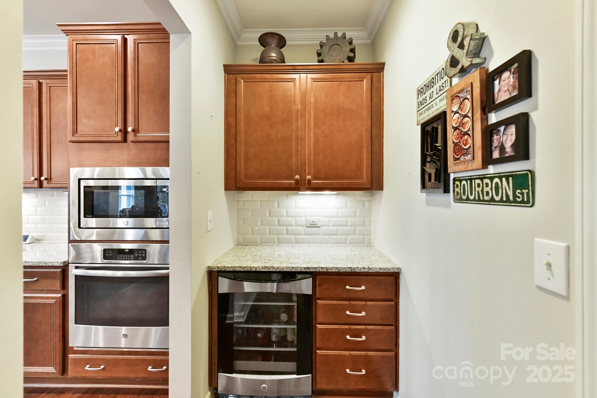 1084 Cameron Creek Parkway Tega Cay, SC 29708 - Photo 11 of 25 a kitchen with granite countertop stainless steel appliances and wooden cabinets