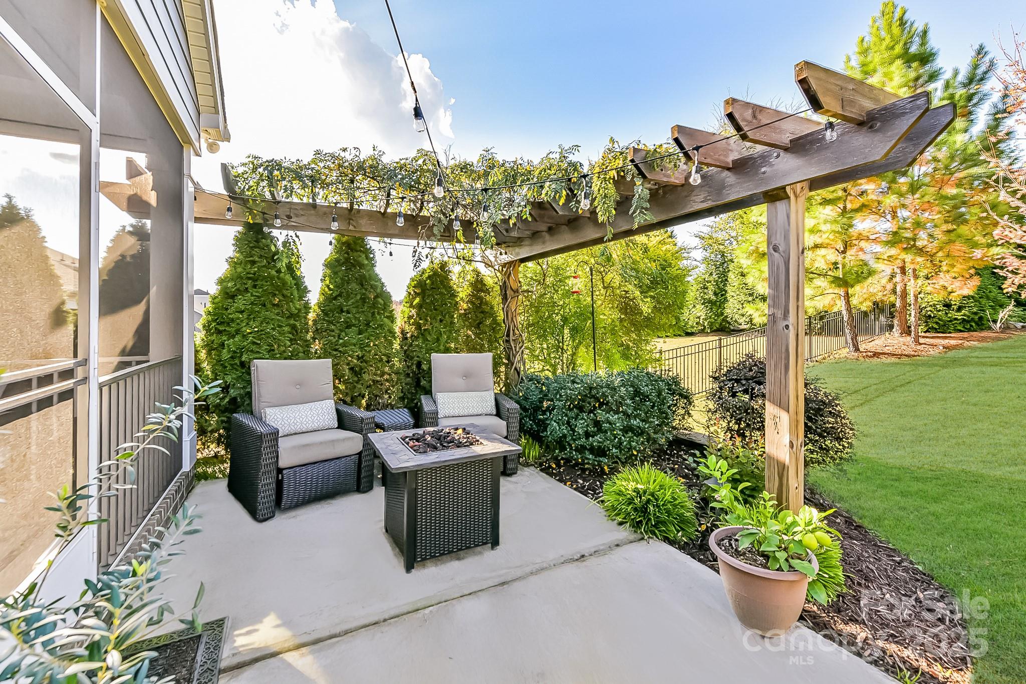 1084 Cameron Creek Parkway Tega Cay, SC 29708 - Photo 22 of 25 a view of a chairs and table in the patio next to a yard