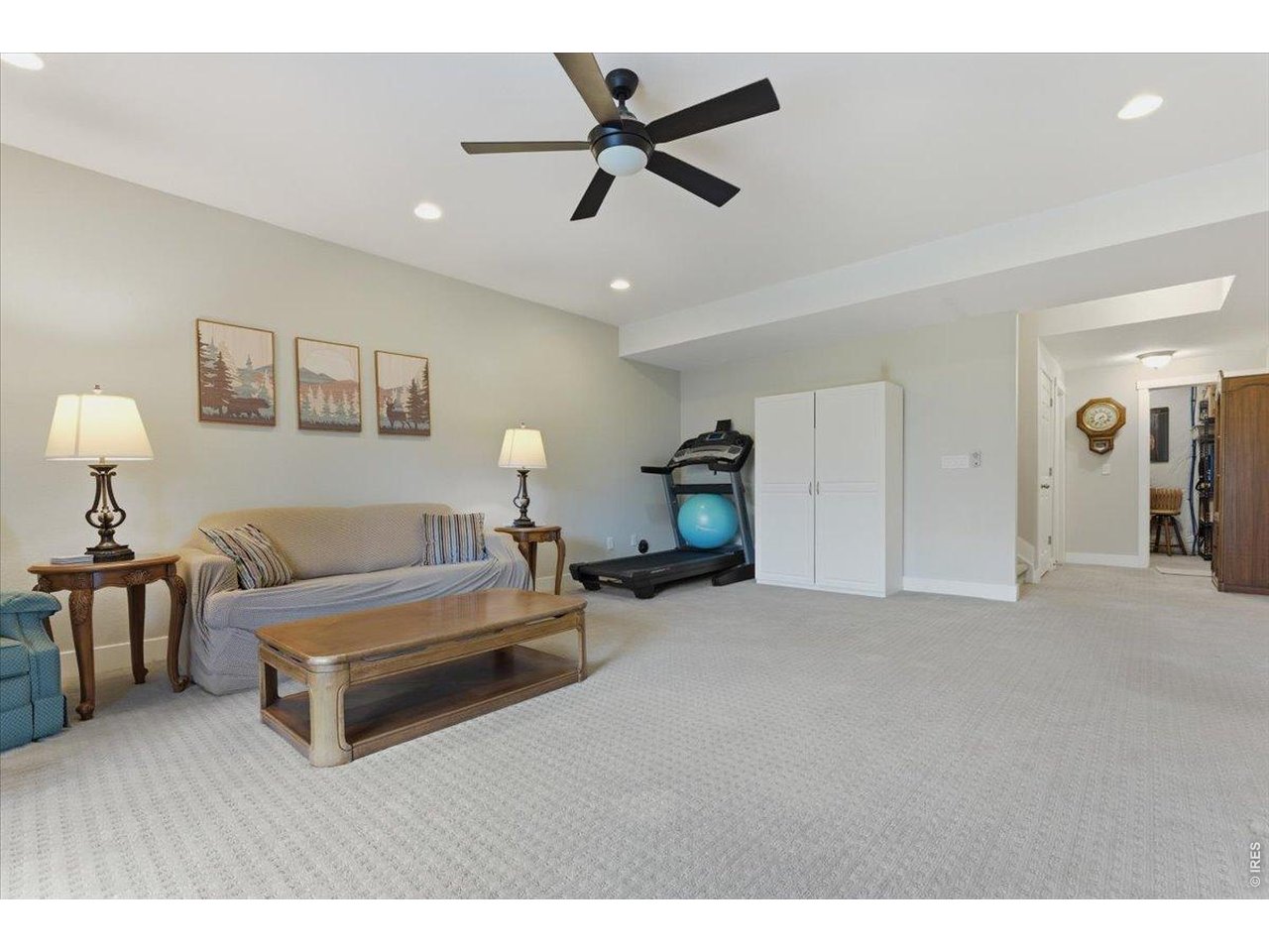 1148 Wagon Bend Road Berthoud, CO 80513 - Photo 38 of 50 a living room with furniture a ceiling fan and a rug