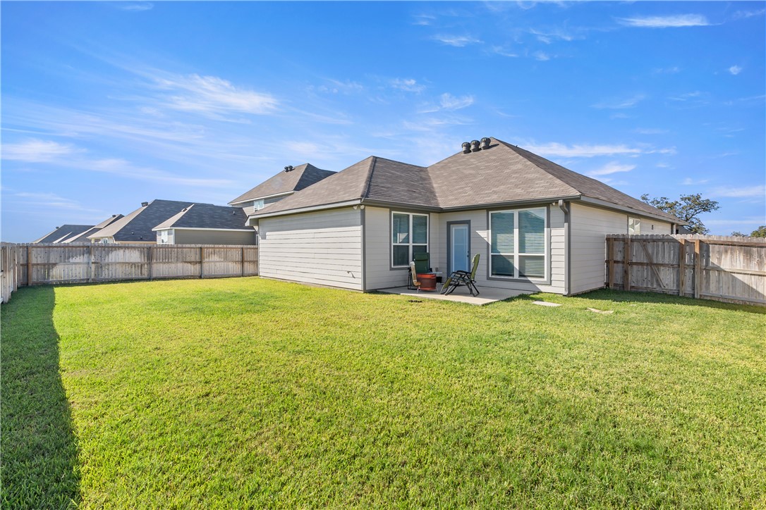 1925 Viva Road Bryan, TX 77807 - Photo 14 of 25 Back of house with a fenced backyard, a patio area, and a shingled roof