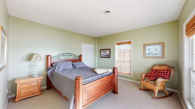 a dining room with furniture a chandelier and wooden floor