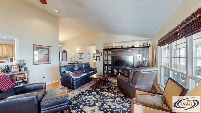a living room with furniture and a book shelf