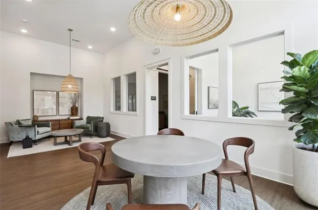 a dining room with furniture and wooden floor