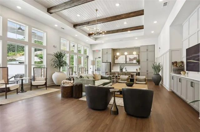 a living room with lots of furniture and wooden floor