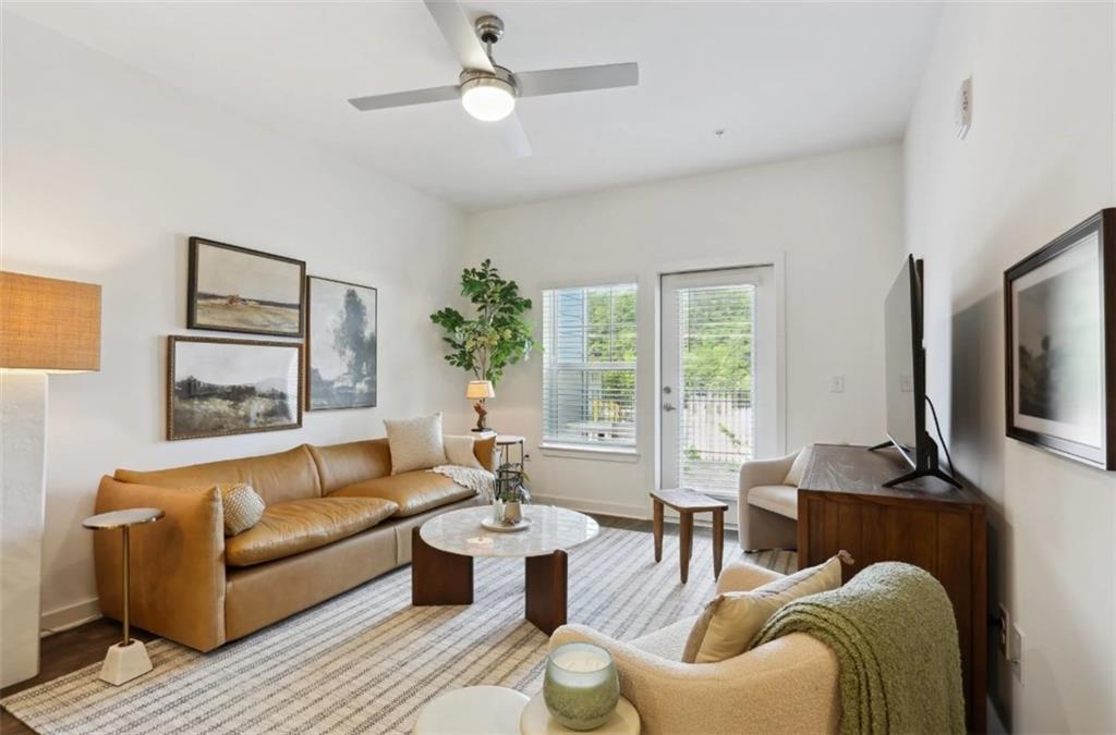 75 Overlook Parkway Southeast, Unit 437 Cartersville, GA 30121 - Photo 5 of 20 a living room with furniture a large window and a flat screen tv