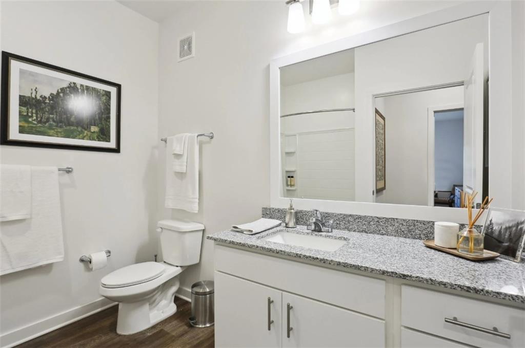 75 Overlook Parkway Southeast, Unit 437 Cartersville, GA 30121 - Photo 7 of 20 a bathroom with a granite countertop toilet sink and mirror