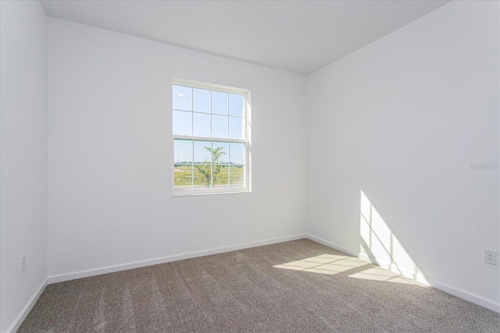 1010 Swamp Chestnut Loop Lady Lake, FL 32159 - Photo 11 of 22 an empty room with windows