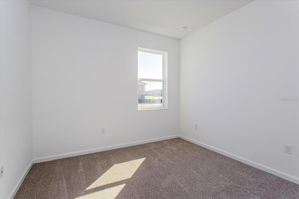 1010 Swamp Chestnut Loop Lady Lake, FL 32159 - Photo 13 of 22 an empty room with a window