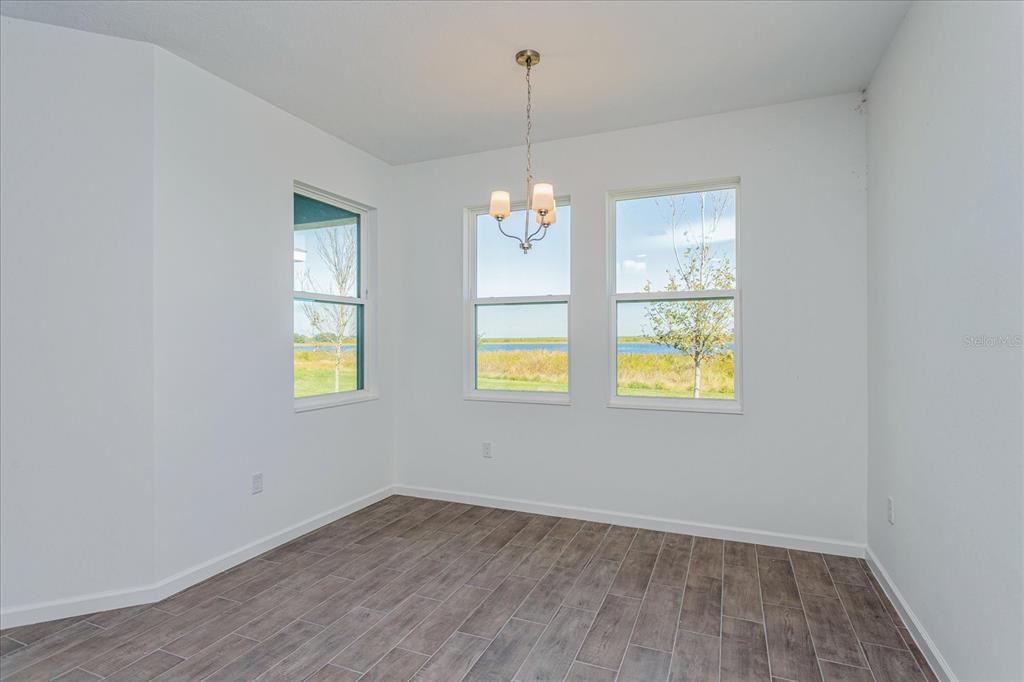 1010 Swamp Chestnut Loop Lady Lake, FL 32159 - Photo 7 of 22 a view of an entryway with wooden floor and windows