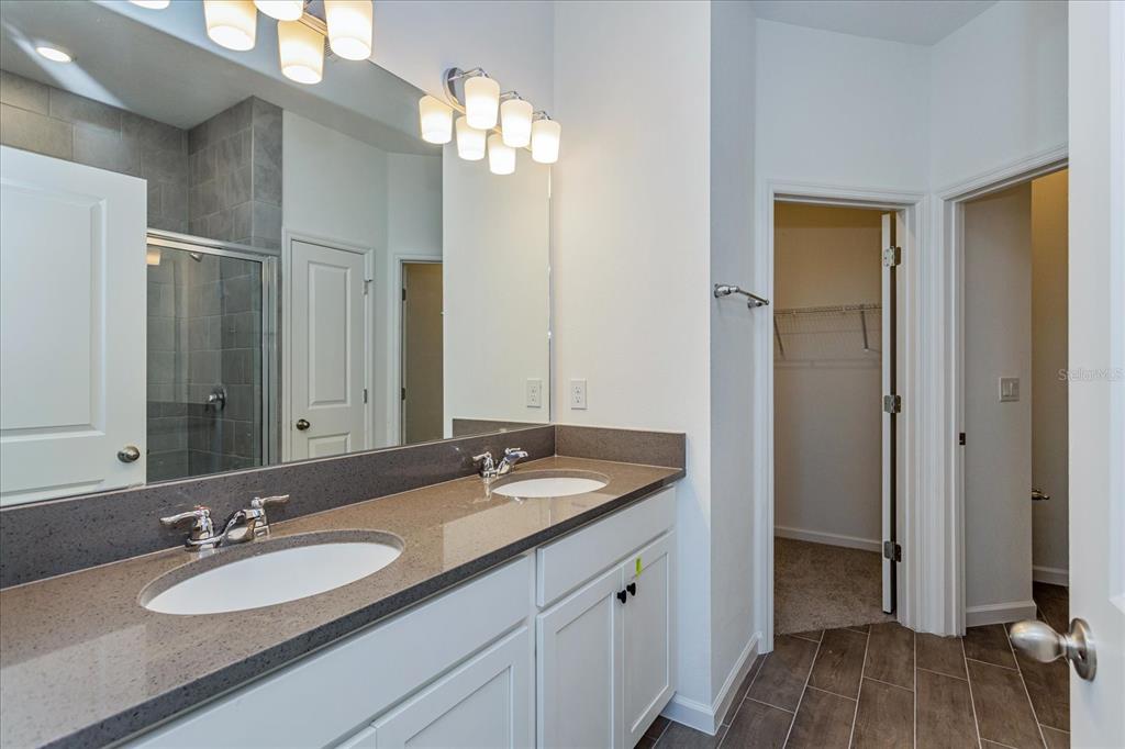 1010 Swamp Chestnut Loop Lady Lake, FL 32159 - Photo 9 of 22 a bathroom with a sink double vanity and a mirror