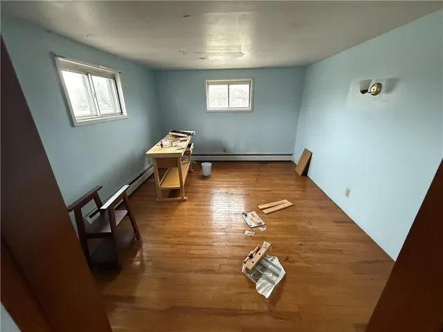 a view of a livingroom with wooden floor and a window