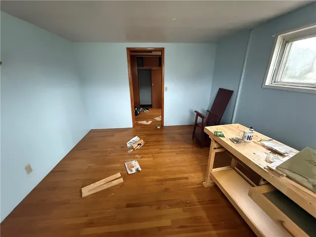 a view of a room with wooden floor