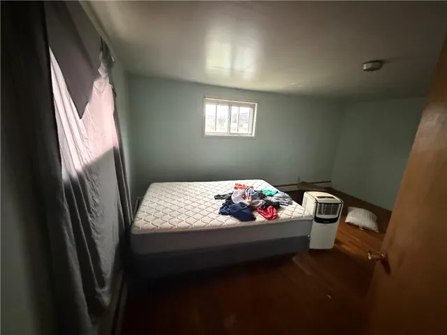 a bedroom with furniture and window