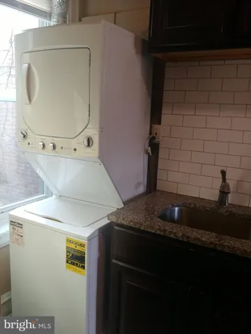 a bathroom with a granite countertop sink a mirror and vanity