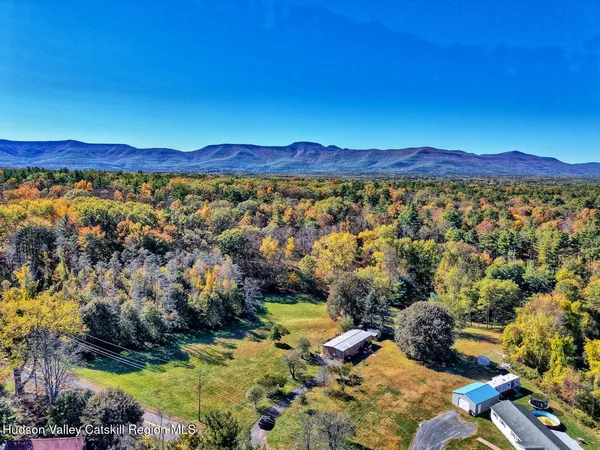 a dining room with furniture a chandelier and wooden floor