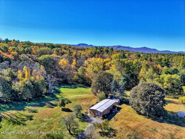 a kitchen with granite countertop a refrigerator a sink dishwasher stove and oven with wooden cabinets