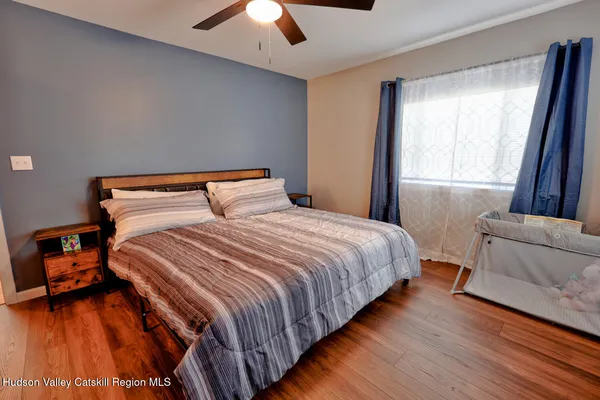 a bed sitting in a bedroom and chandelier