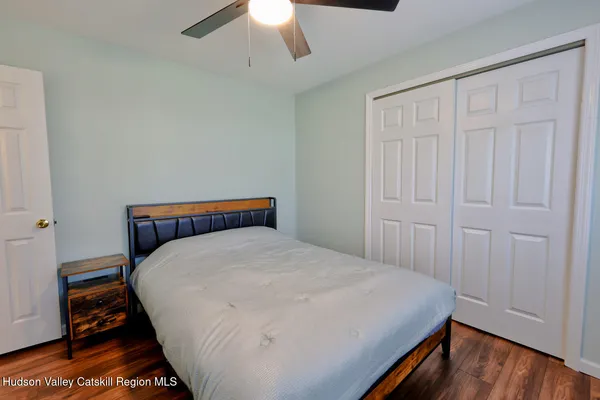 a front view of house with yard and trees in the background
